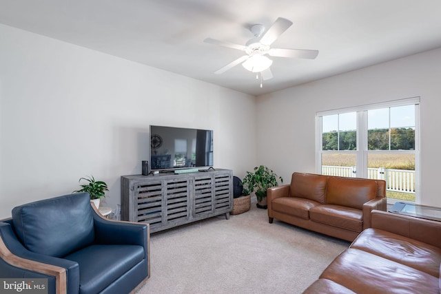 living room featuring light carpet and ceiling fan