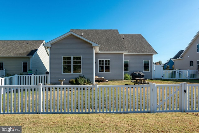 back of property featuring a yard