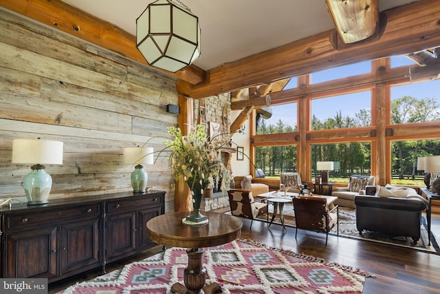 living room with wood walls, dark hardwood / wood-style floors, and a high ceiling