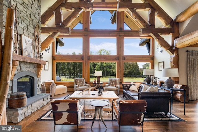 living room featuring a fireplace, dark hardwood / wood-style floors, and high vaulted ceiling