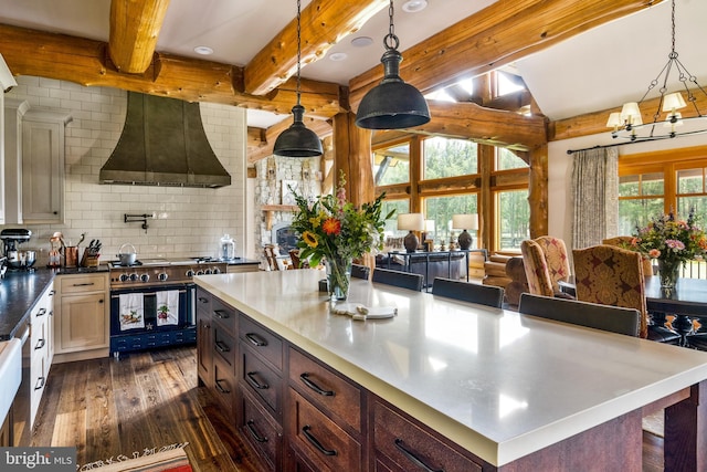 kitchen featuring beamed ceiling, tasteful backsplash, decorative light fixtures, dark hardwood / wood-style floors, and custom range hood