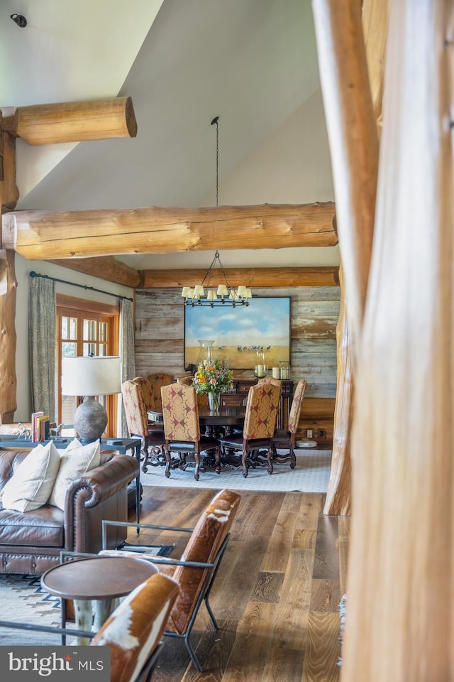 living room with high vaulted ceiling, a notable chandelier, and hardwood / wood-style flooring