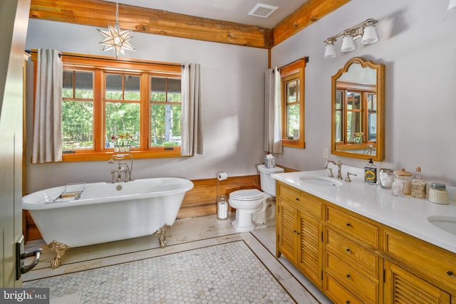 bathroom featuring beamed ceiling, vanity, a tub, tile patterned floors, and toilet