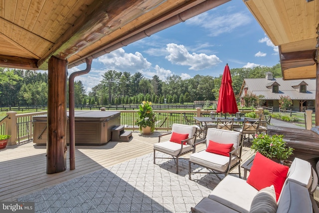 view of patio / terrace with a hot tub and a deck