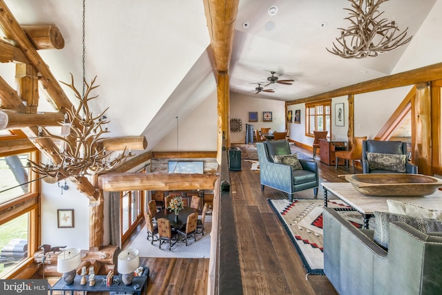 living room with dark wood-type flooring, ceiling fan with notable chandelier, and high vaulted ceiling