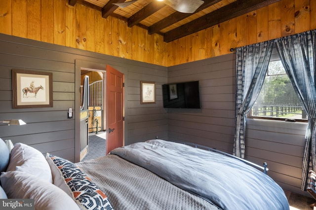 bedroom featuring beamed ceiling, wooden walls, and wooden ceiling