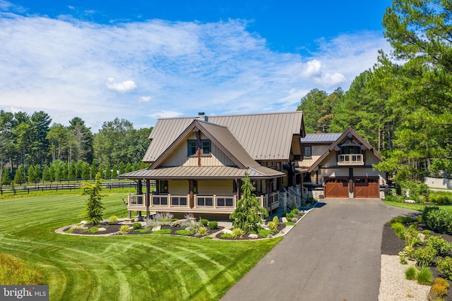 view of front of property featuring a garage, a porch, and a front yard