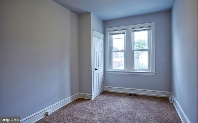 unfurnished room featuring carpet flooring