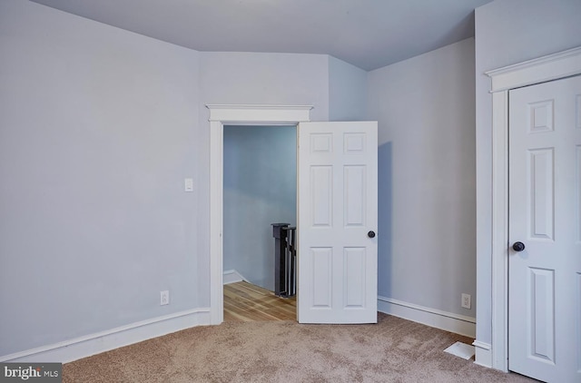 unfurnished bedroom with light colored carpet