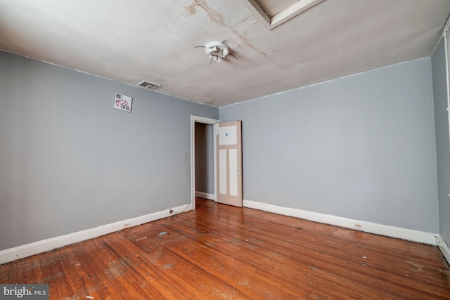 empty room with hardwood / wood-style flooring