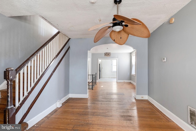 entryway featuring light wood-type flooring and a textured ceiling