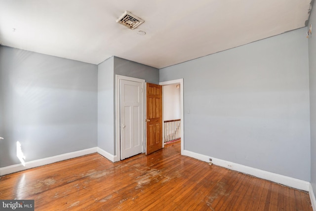 unfurnished room with hardwood / wood-style flooring