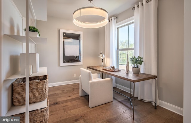 office space with plenty of natural light and hardwood / wood-style floors