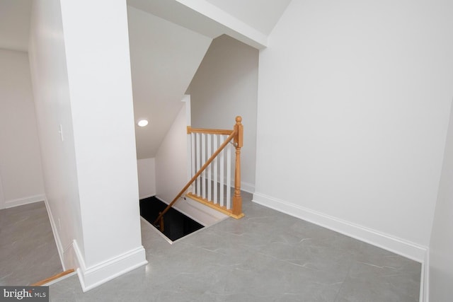 stairs featuring concrete flooring