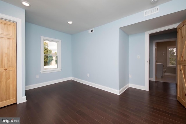 empty room featuring dark wood-type flooring