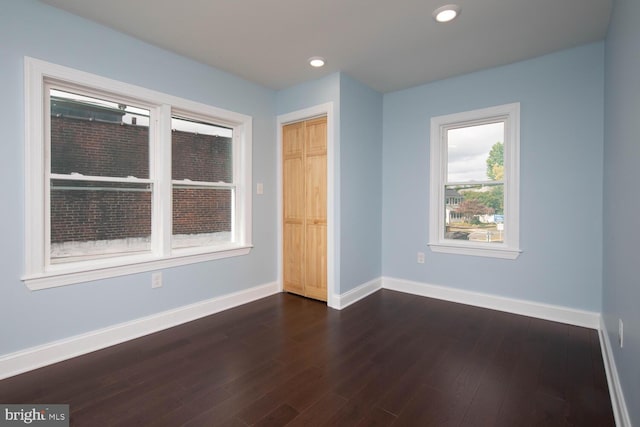 spare room with dark hardwood / wood-style floors