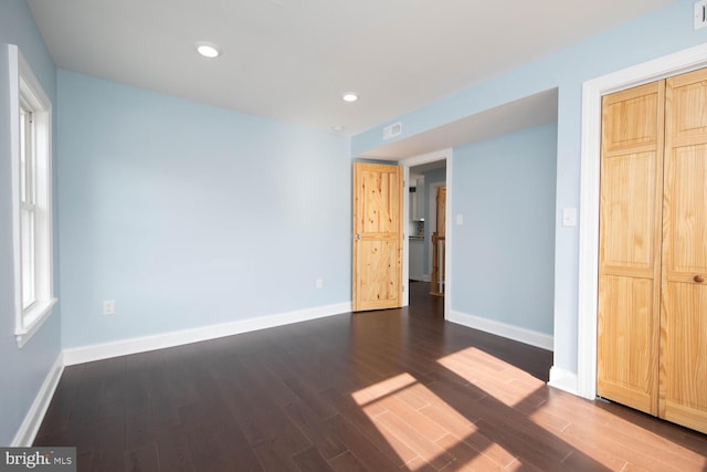 unfurnished bedroom featuring dark hardwood / wood-style flooring