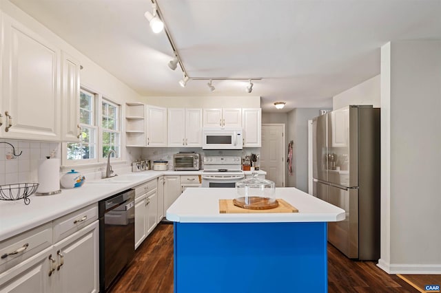 kitchen with white appliances, dark hardwood / wood-style floors, sink, and a center island