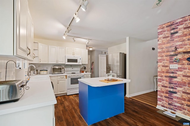 kitchen featuring dark hardwood / wood-style floors, white cabinetry, white appliances, and a kitchen island