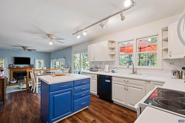 kitchen with black dishwasher, blue cabinetry, dark hardwood / wood-style flooring, sink, and decorative backsplash