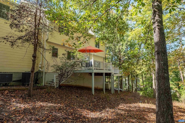 back of house featuring central AC and a deck