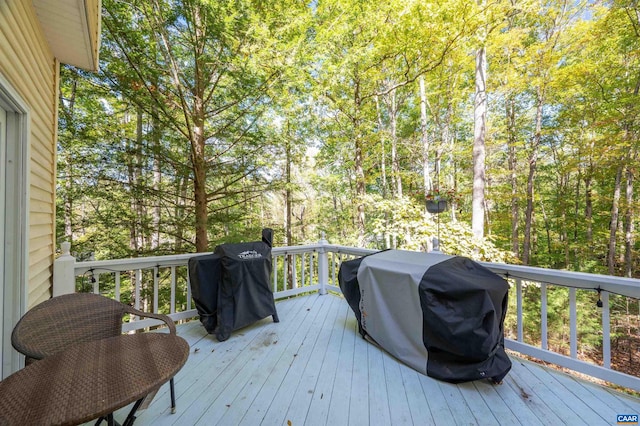 wooden terrace with a grill