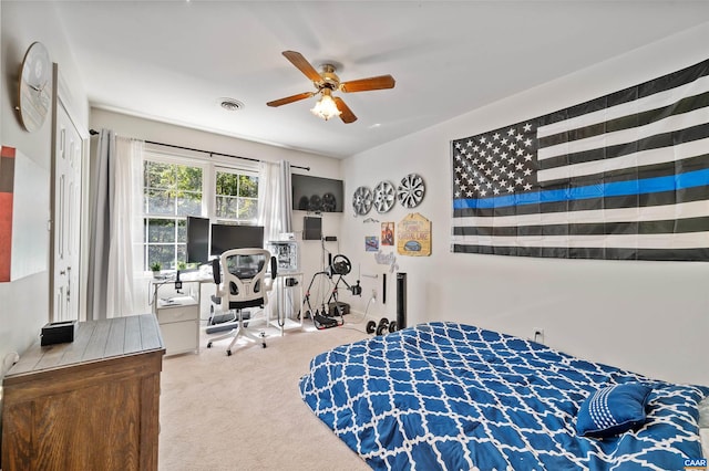 bedroom featuring ceiling fan and carpet