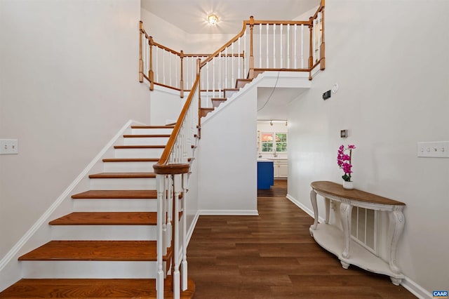 stairs featuring hardwood / wood-style flooring