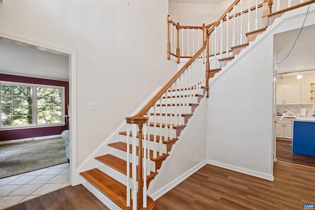 stairs featuring track lighting and wood-type flooring