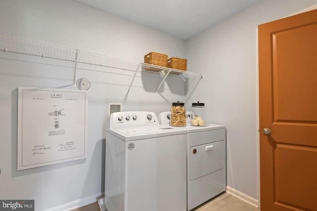 laundry area featuring washer and dryer, laundry area, and baseboards