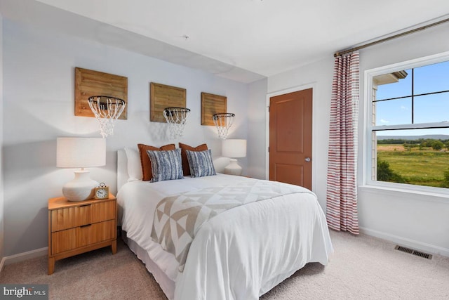 bedroom featuring visible vents, baseboards, and light colored carpet