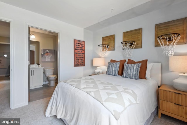 bedroom featuring carpet flooring and ensuite bath