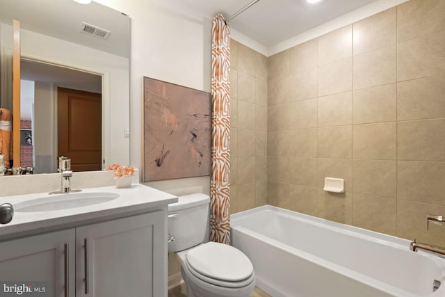bathroom with toilet, vanity, shower / bath combination with curtain, and visible vents