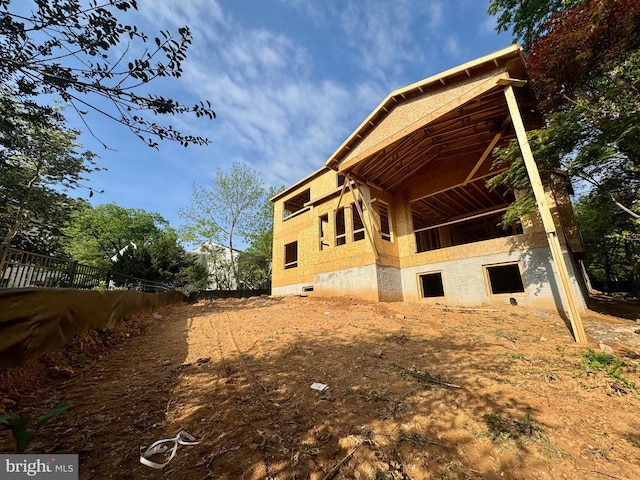view of side of home with fence