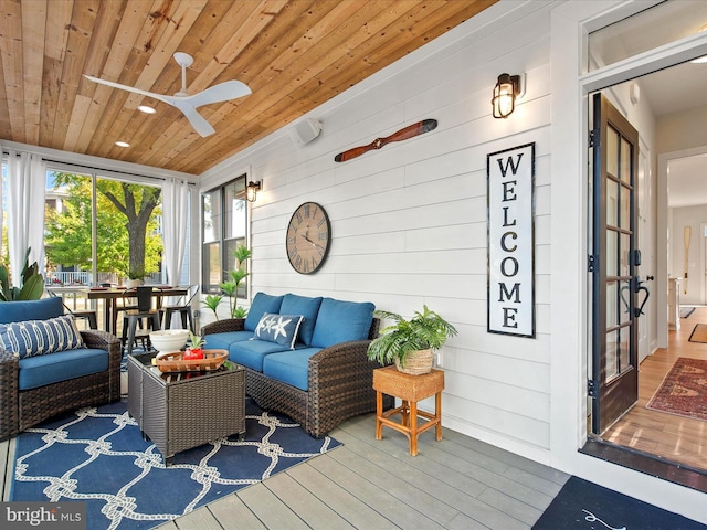 sunroom / solarium with ceiling fan and wood ceiling