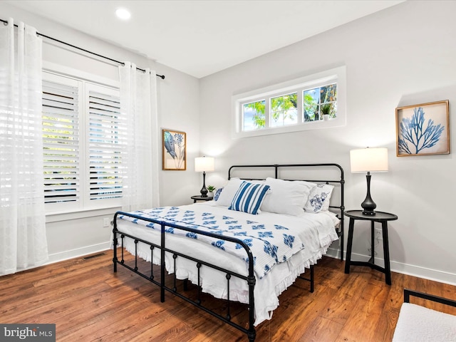 bedroom with hardwood / wood-style flooring