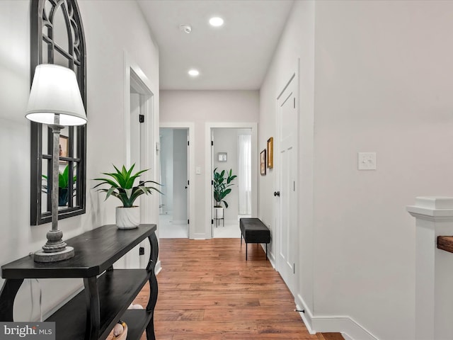 hall with hardwood / wood-style flooring