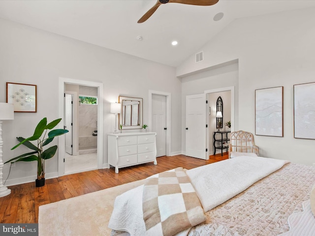 bedroom with ensuite bathroom, ceiling fan, vaulted ceiling, and wood-type flooring