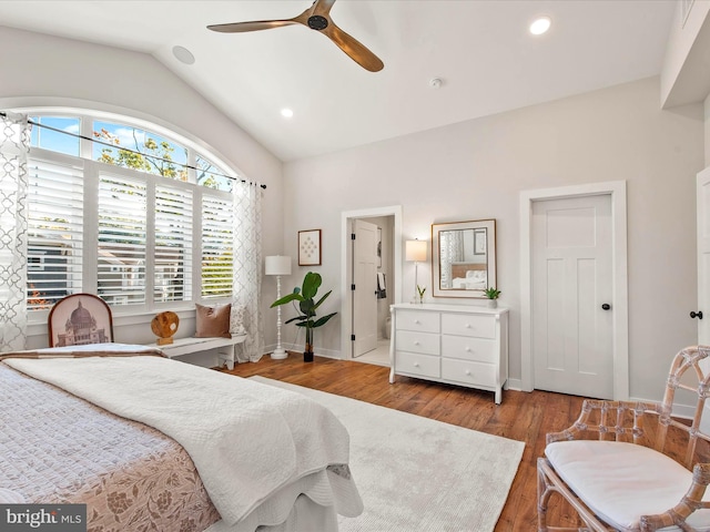 bedroom featuring ceiling fan, lofted ceiling, ensuite bathroom, and wood-type flooring