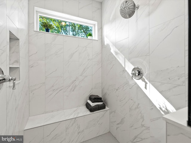 bathroom with tiled shower