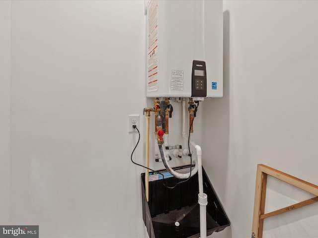 utility room with tankless water heater