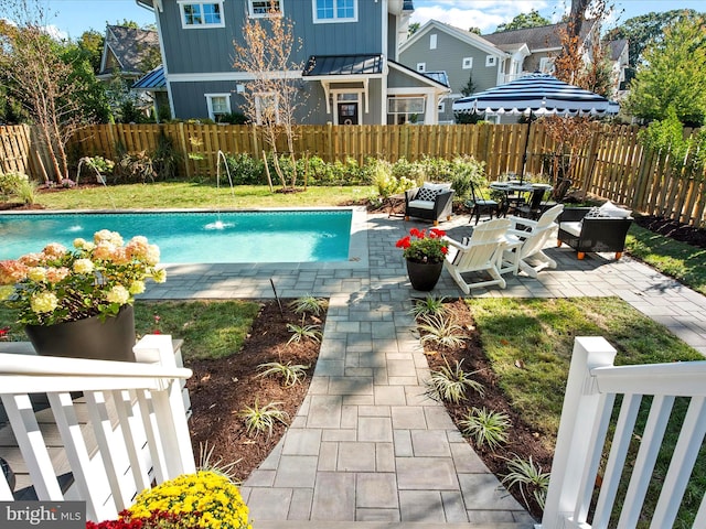 view of pool with pool water feature and a patio area