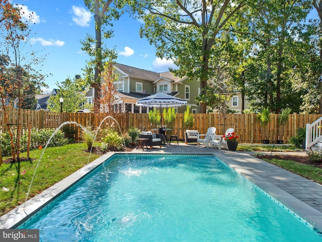 view of pool featuring pool water feature and a patio area