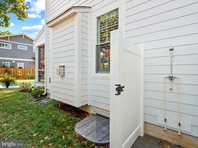 property entrance featuring a lawn