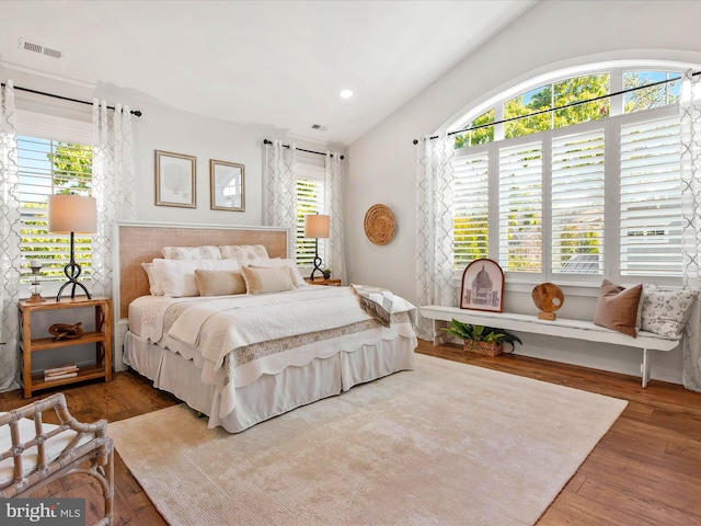 bedroom featuring multiple windows and hardwood / wood-style floors