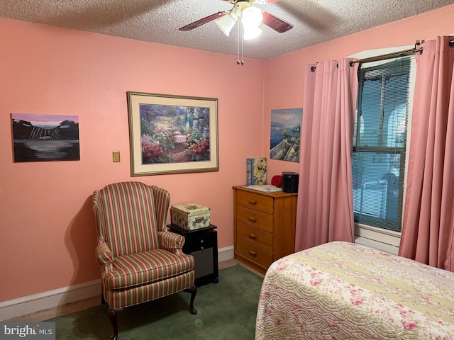 bedroom featuring ceiling fan, a textured ceiling, and dark colored carpet