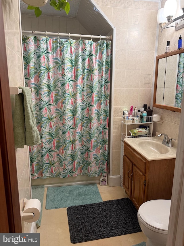 bathroom featuring a shower with curtain, vanity, tile walls, and toilet