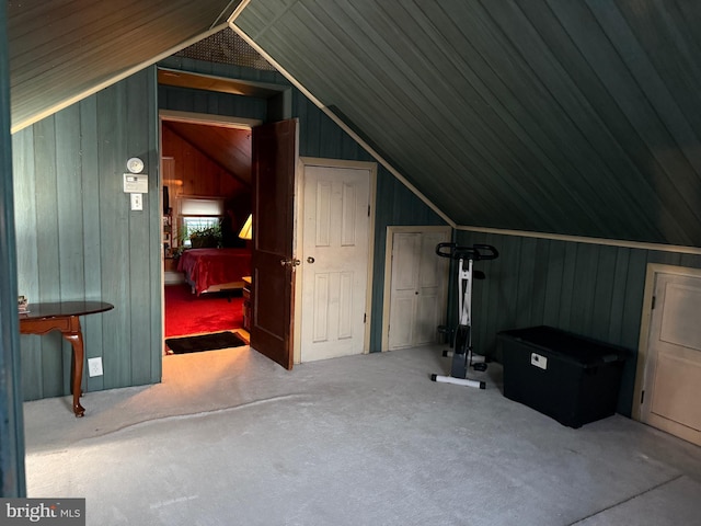 additional living space with wooden walls, lofted ceiling, carpet flooring, and wood ceiling