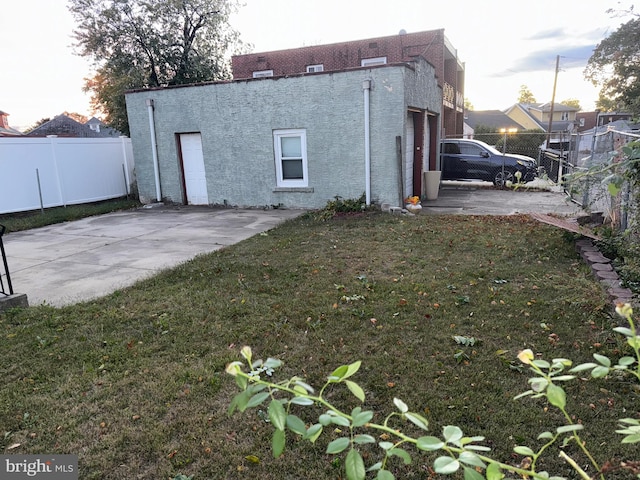 back of property featuring a yard and a patio area