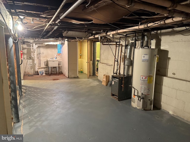 basement with water heater and sink